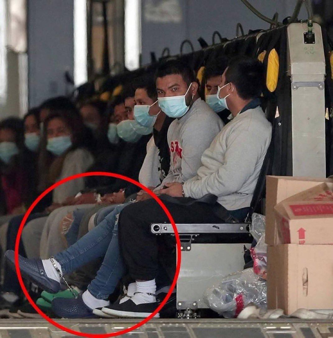 Handcuffed and chained Indian migrants deported from US arrive home on military craft