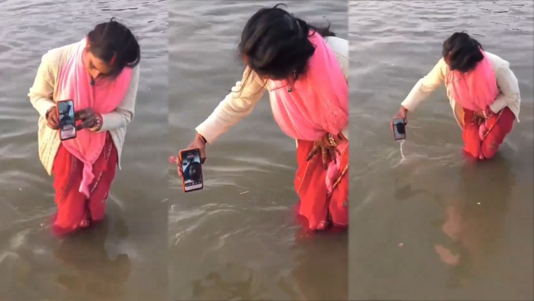 Indian woman dips phone in river to help husband take virtual holy dip